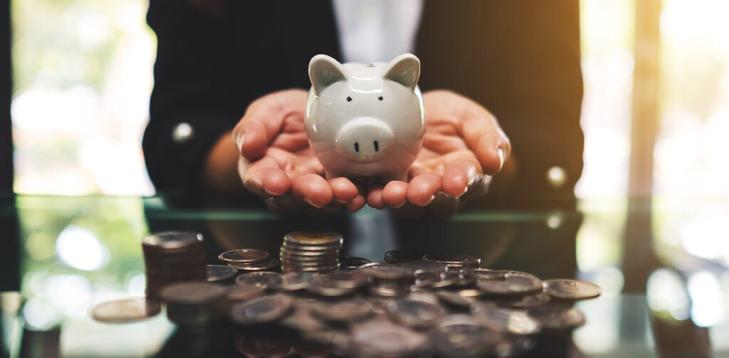 person holding piggie bank financial planning for retirement